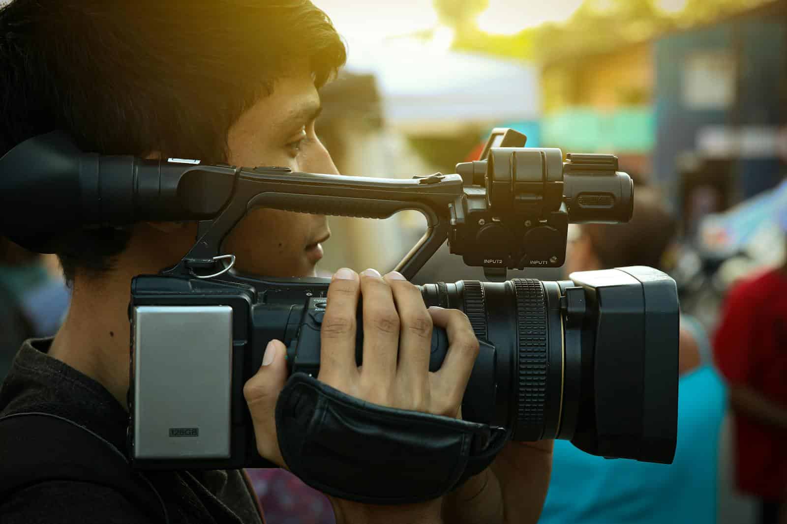 Man Carrying Black Camera